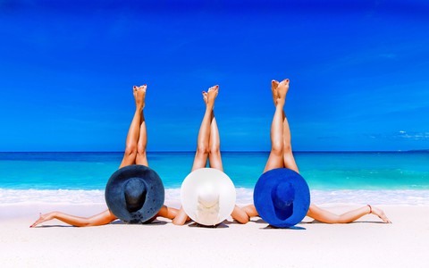Friends Relaxing On Beach