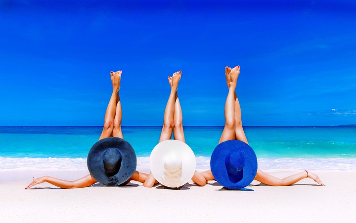 Friends Relaxing On Beach
