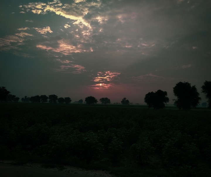 sun behind clouds