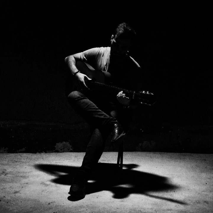 playing guitar in darkness