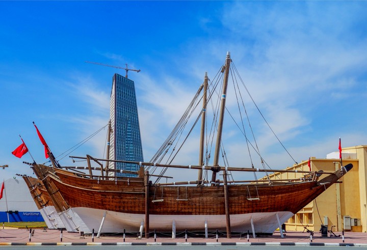 old wooden ship & skyscraper
