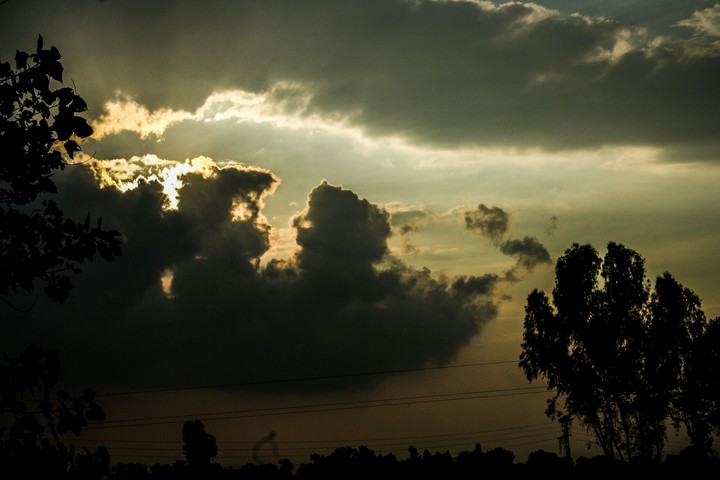 Sun behind some Clouds.