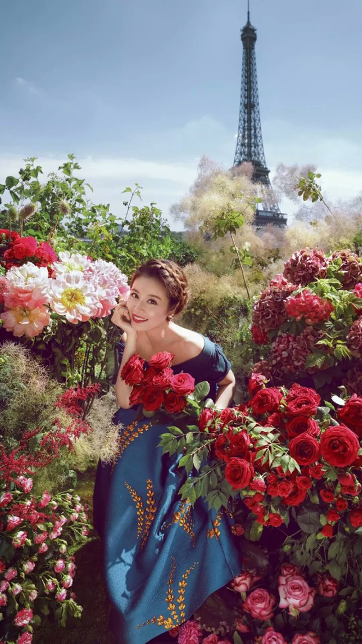 A very beautiful girl, flowers and the osm Eiffel Tower