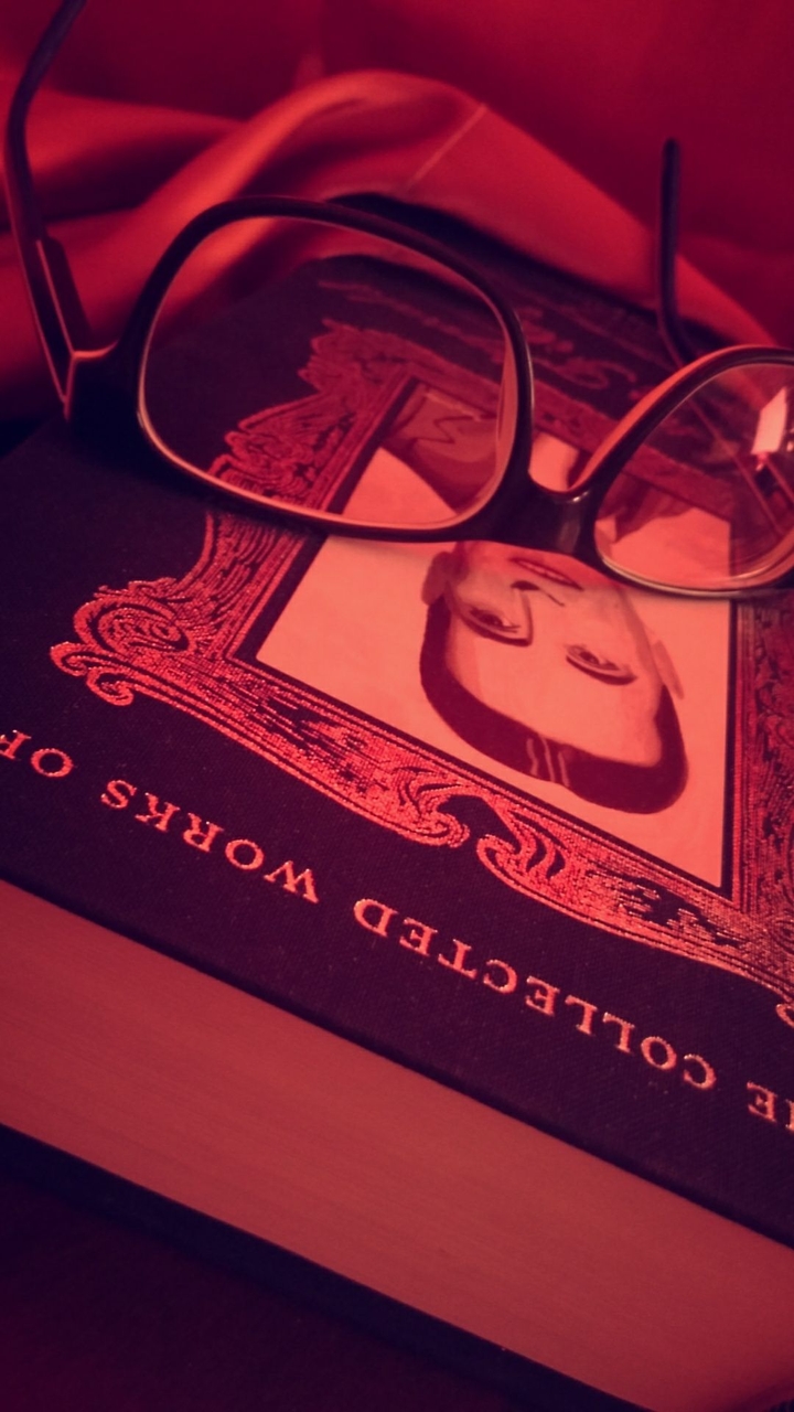 Book, glasses and dark red wine.