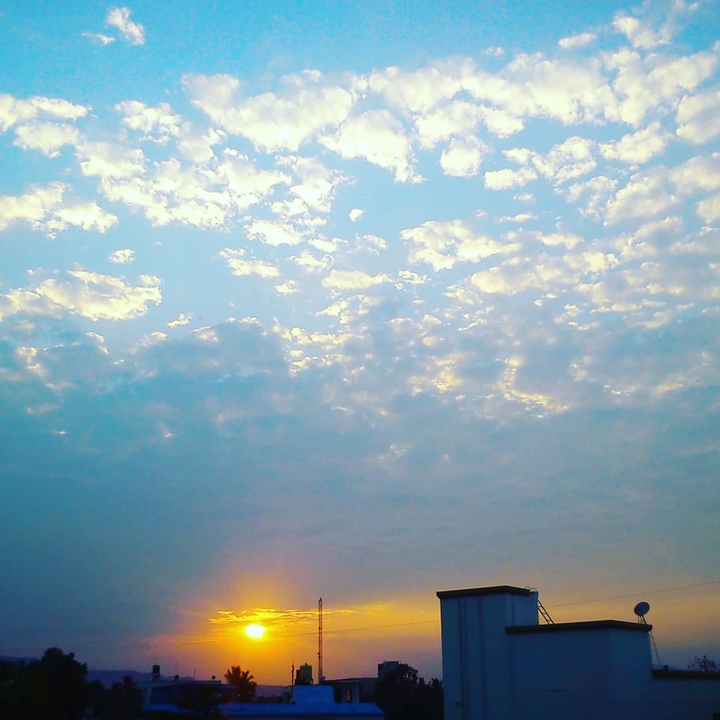 Sunlight spilling out of the clouds.