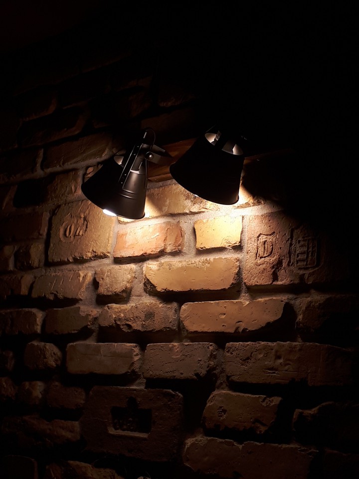 A brickwall illuminated by lamps