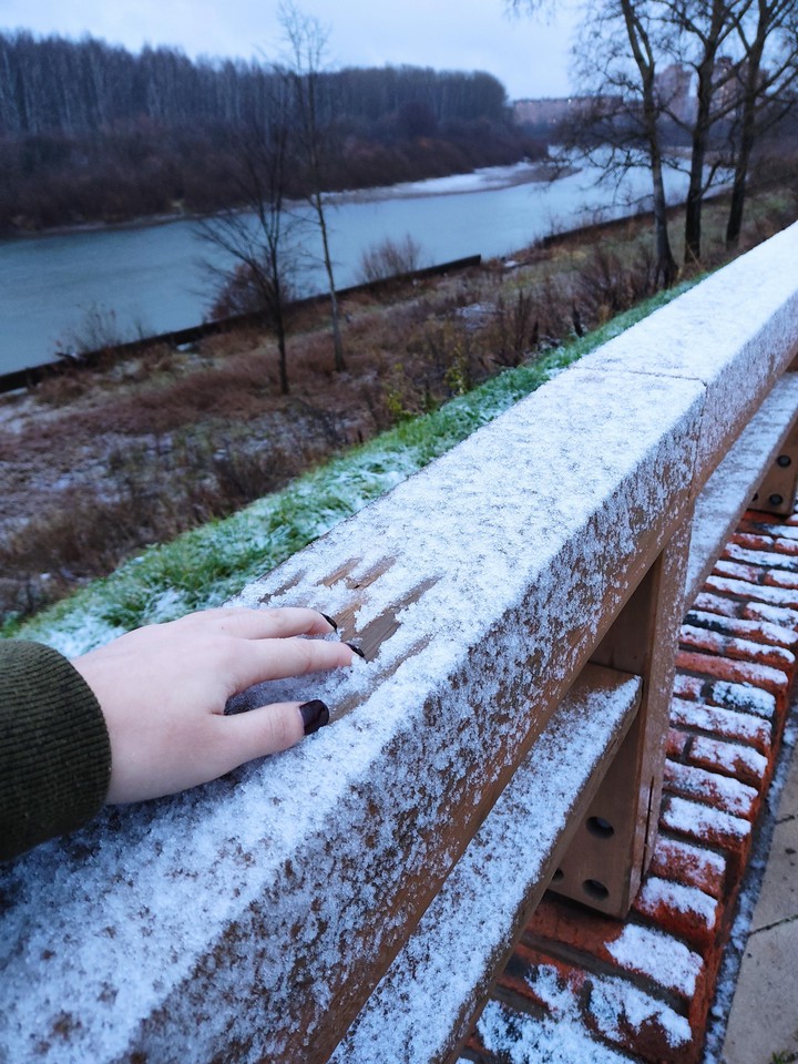hand on snowy bridge