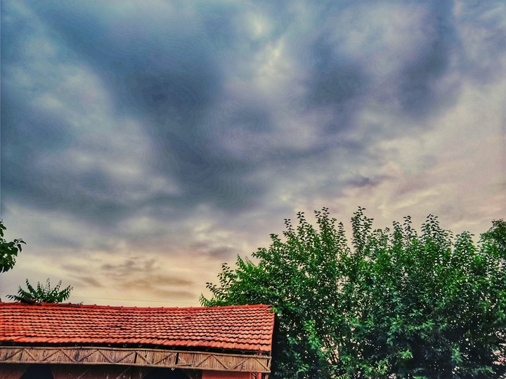 Clouds, hut and trees