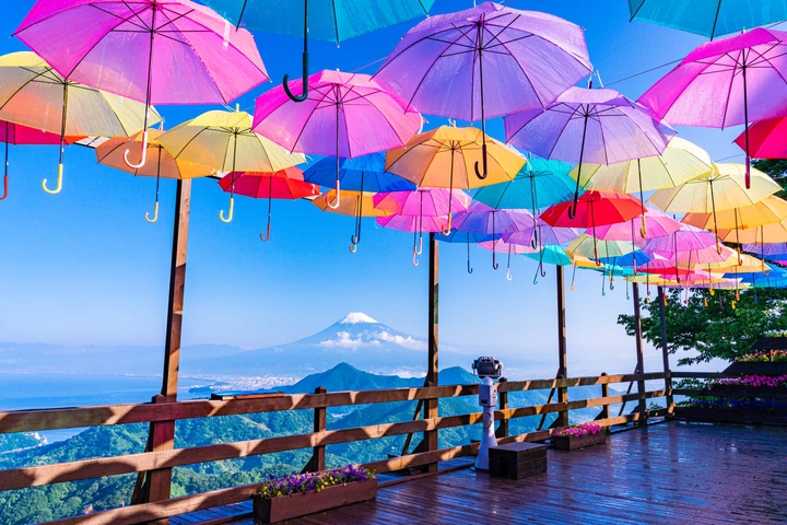 colorful umbrellas frame Mt Fuji