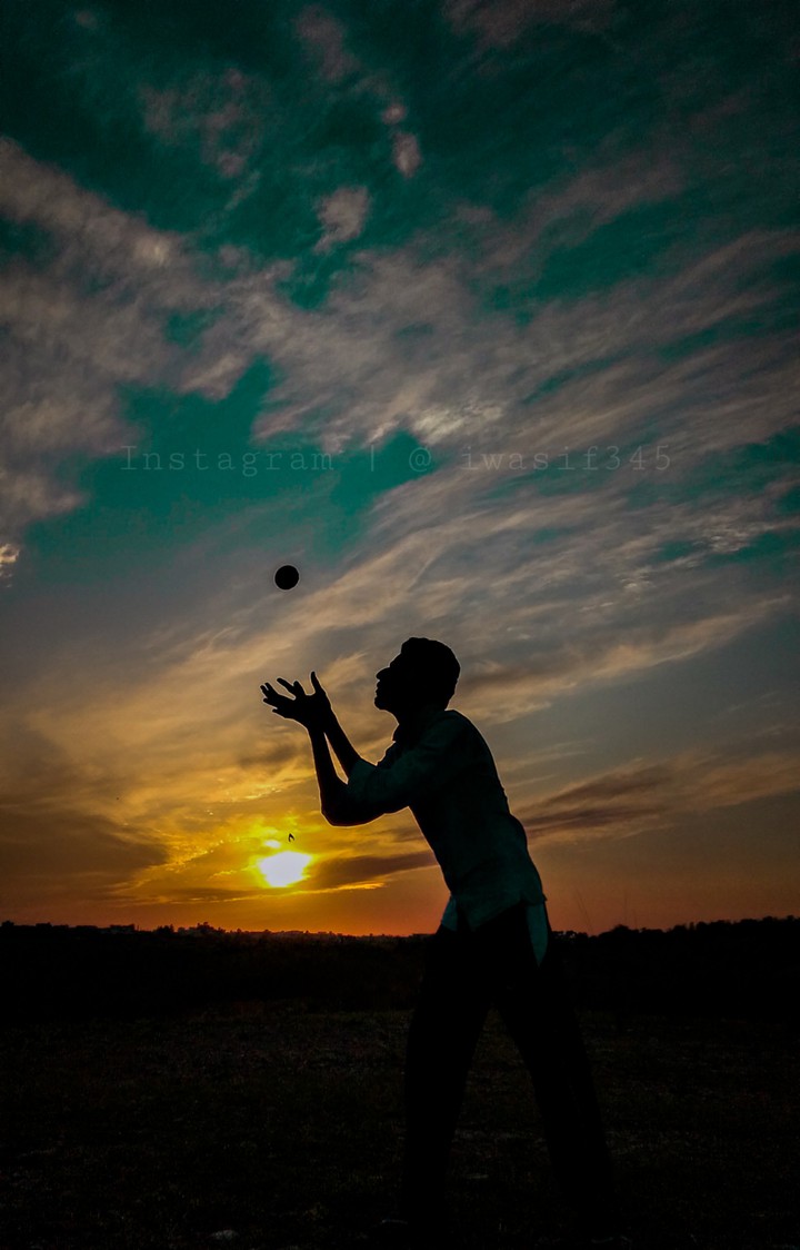 Boy trying to catch a cricket ball