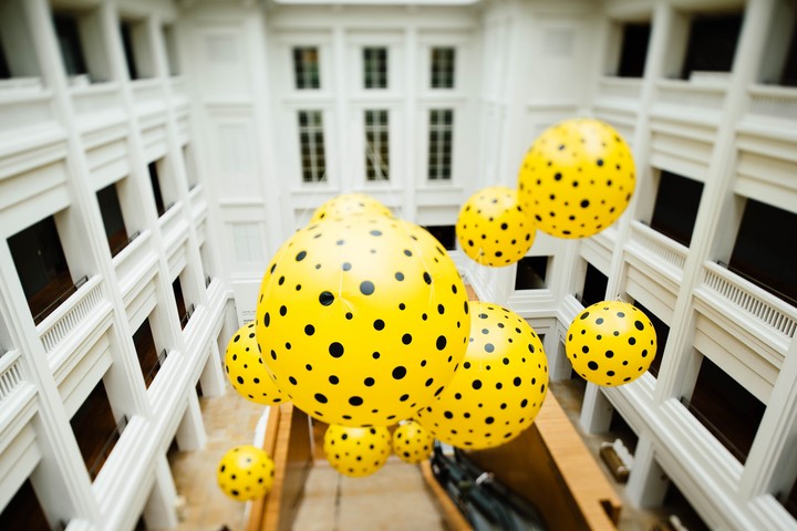 yellow and black polka-dots balloon floating