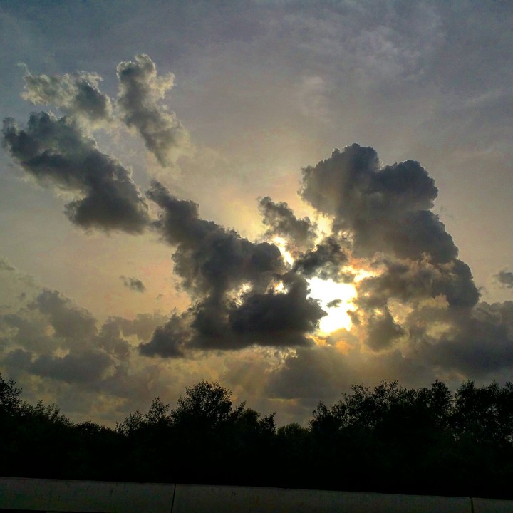 The sun peeking through the evening sky