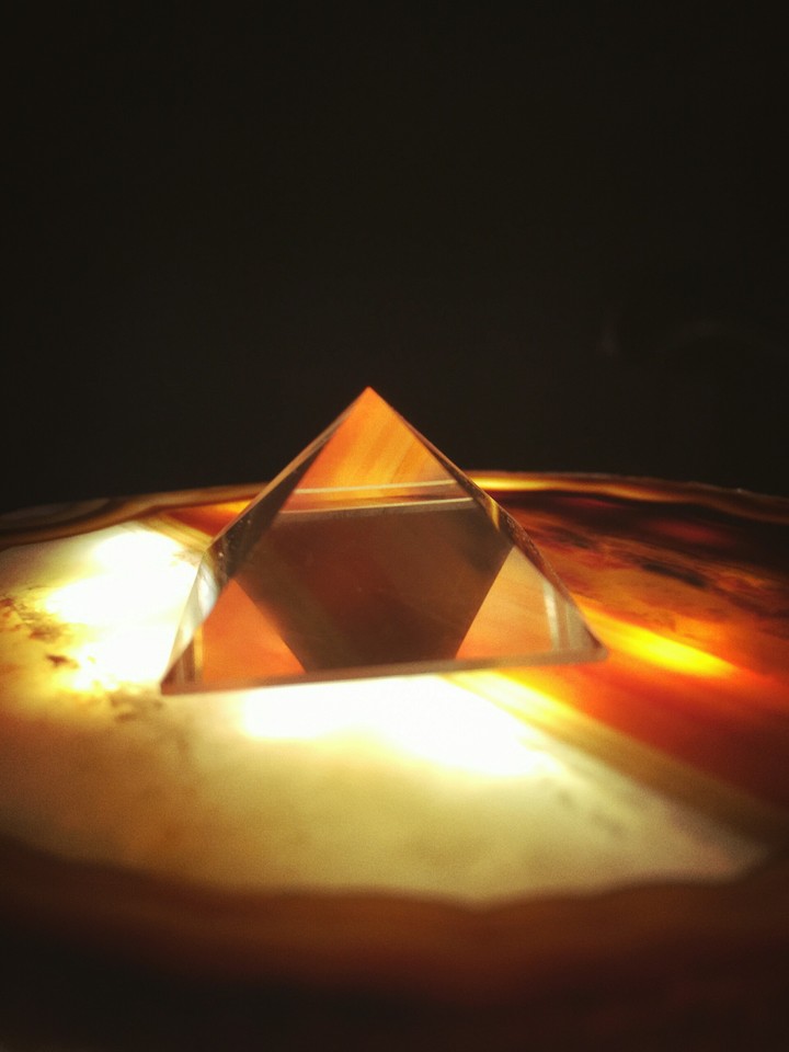orange light through a glass pyramid