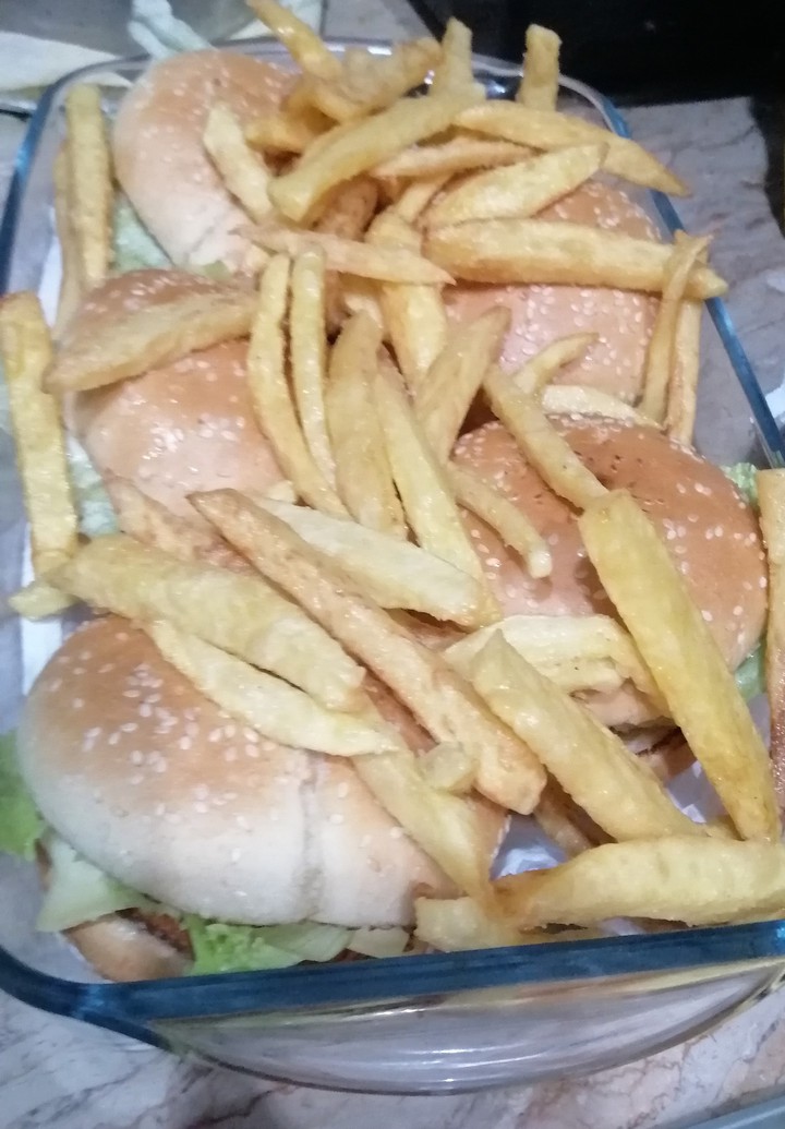 fries lying on bed of burgers