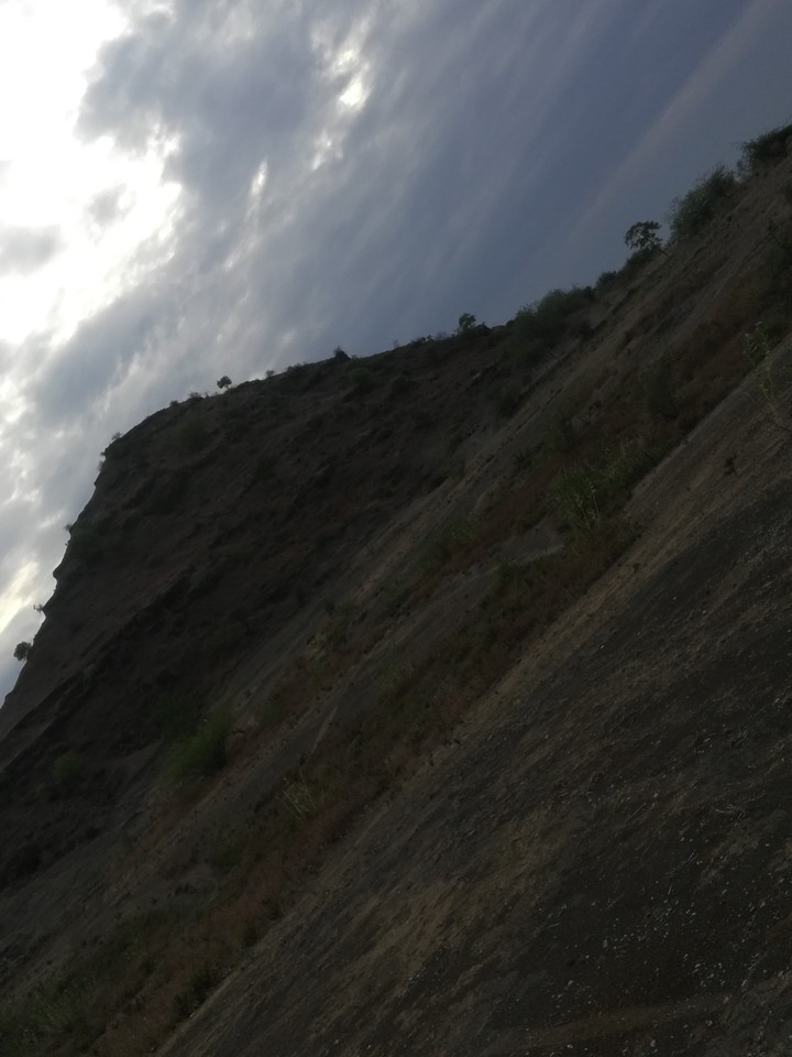 sun behind hill