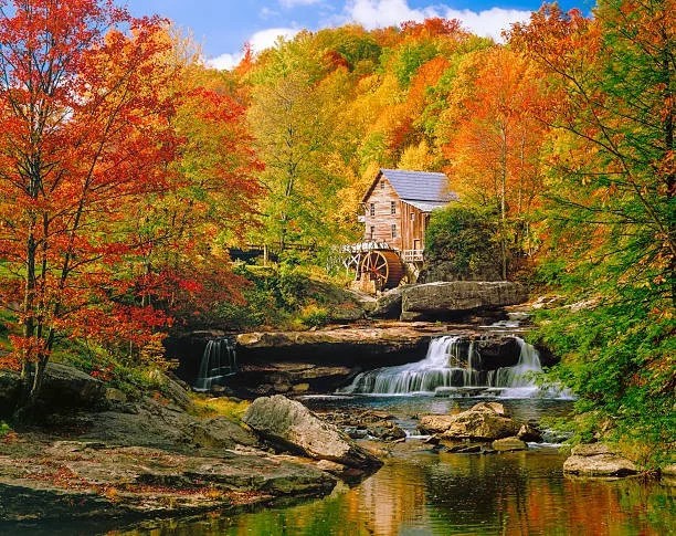 old grist mill and stream in autumn