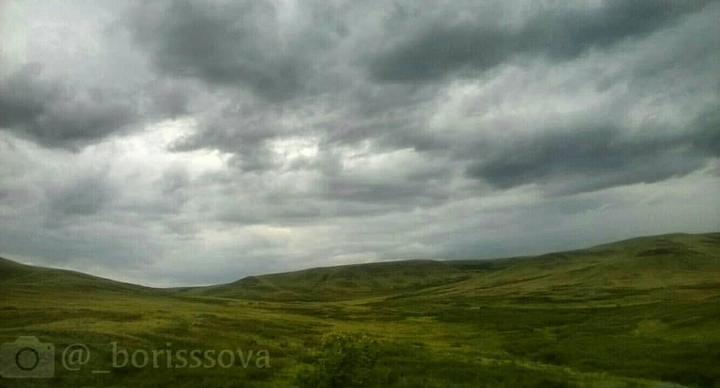 The green field. Hills.
