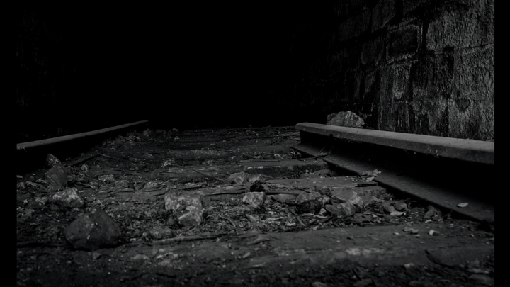 black and white train track tunnel abandoned