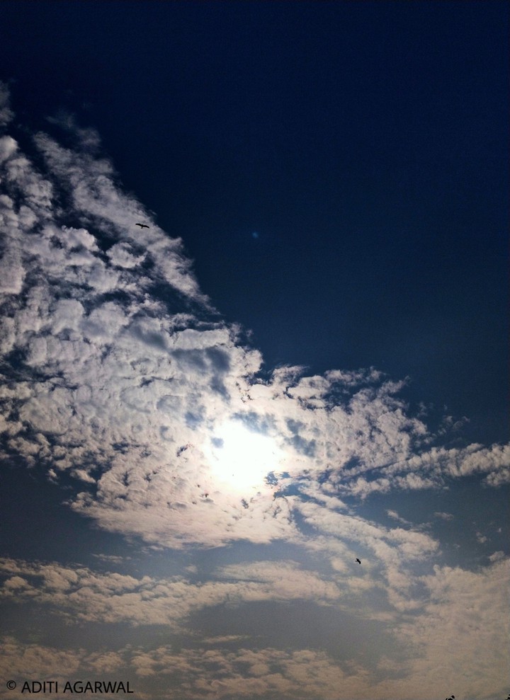 Scattered clouds, Bright sun.