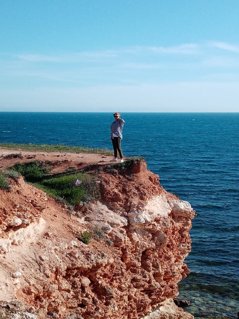 Above the cliff.