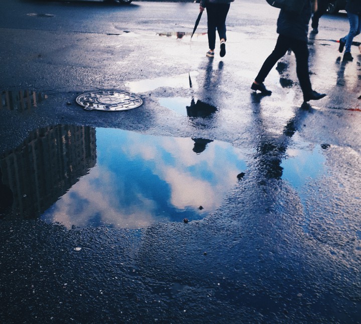 people and puddles from the rain