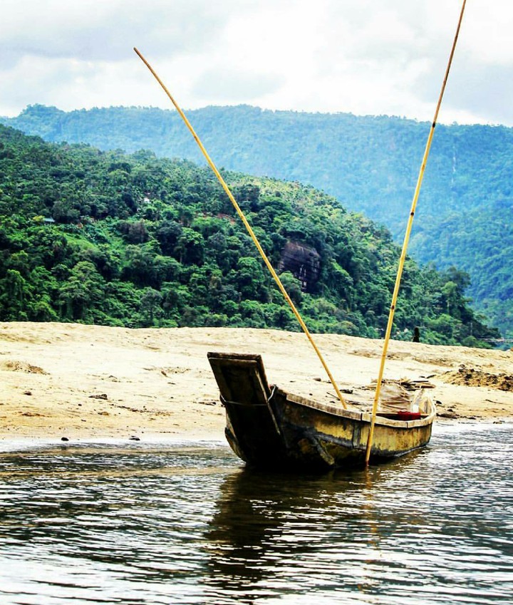Boat On Water Front Of A Hill