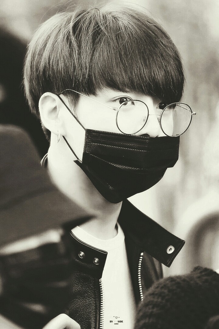 Kookie wearing a mask and glasses