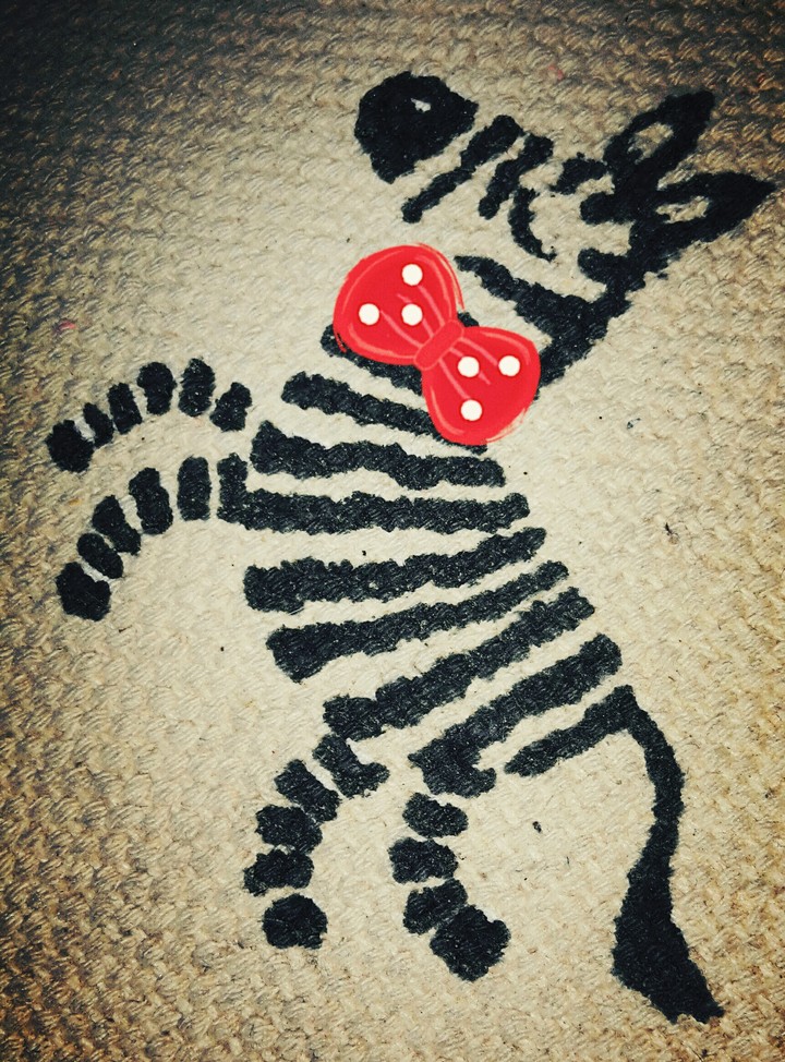 Little Zebra on its Hind Legs Wearing a Bow Tie