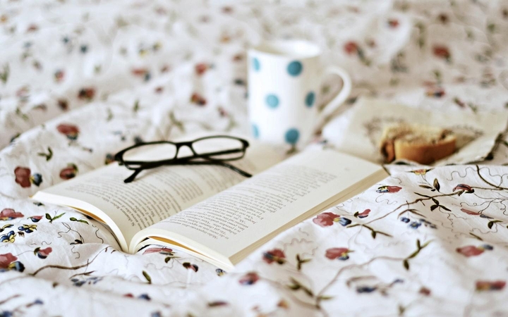 The glasses, mug, and book