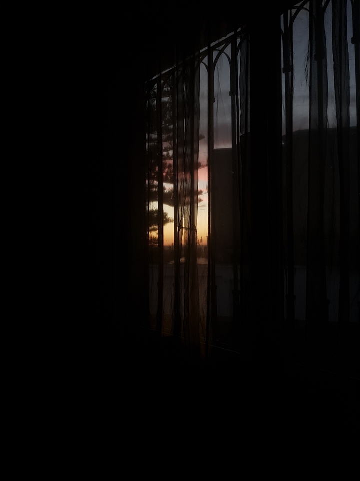 sunset and ripped curtain