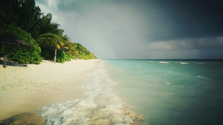 Beach in Maldives with rainbow