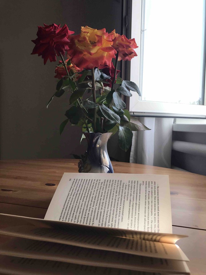 roses and a book are on the table