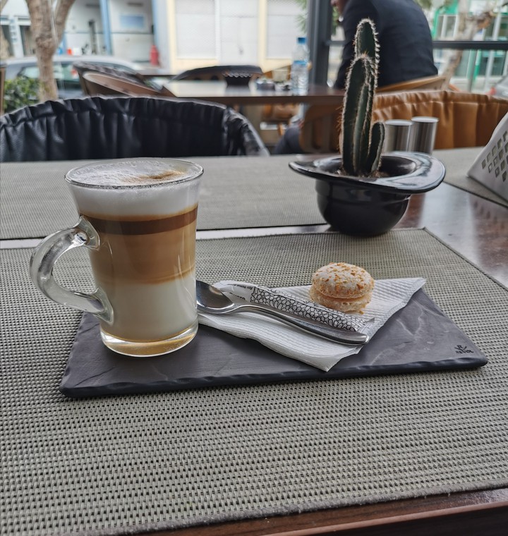 cup of coffee with macaron