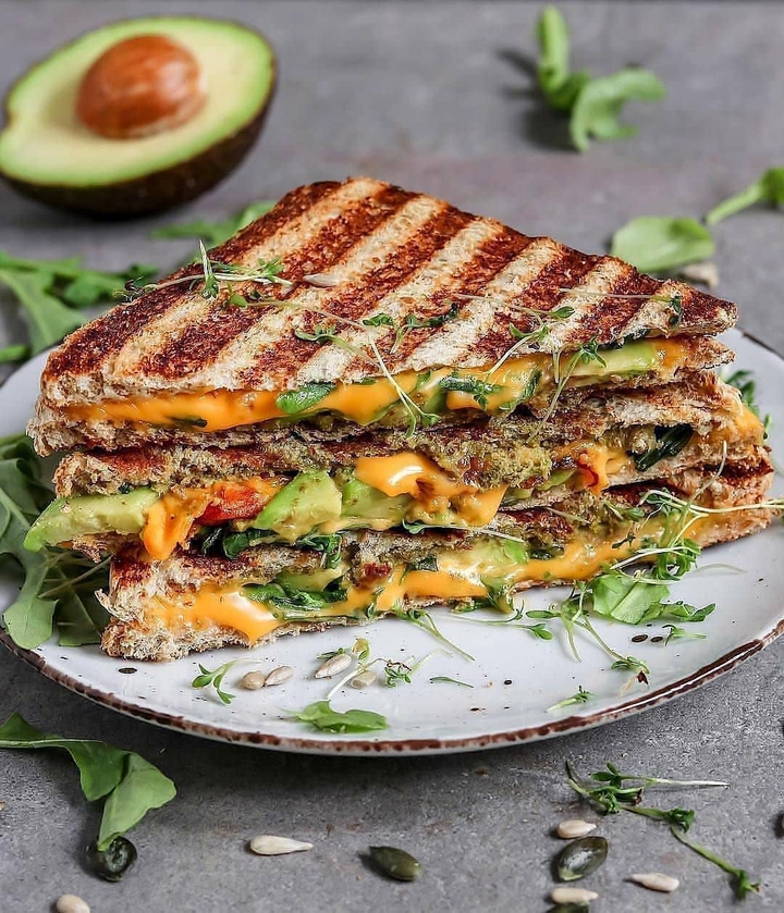 Gilled chesse sandwich with sprouts and avocado