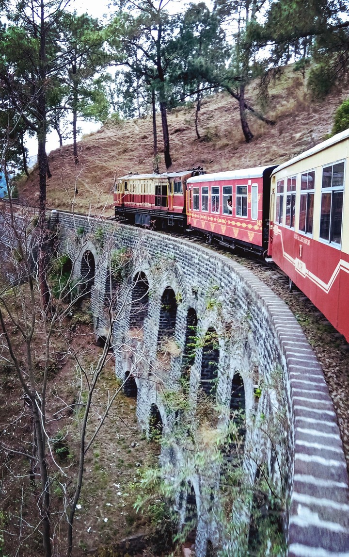 Steam train on stone bridge