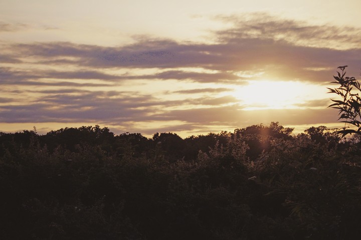 Sun shines under clouds