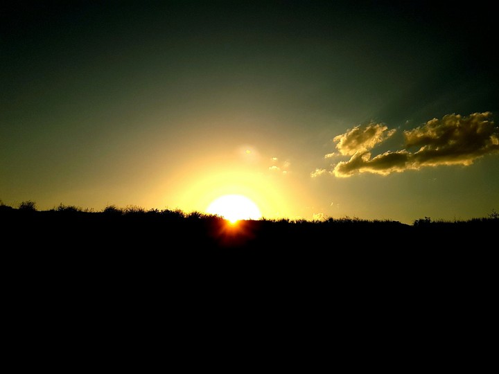 The sun passing the hill at sunrise