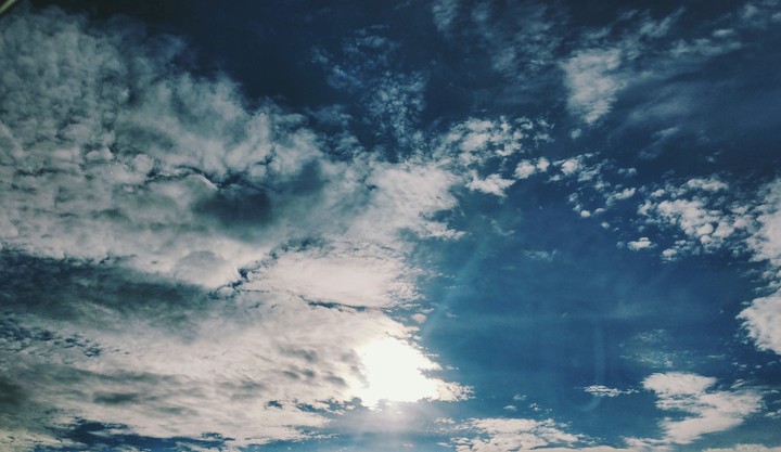 the sun hiding behind the clouds