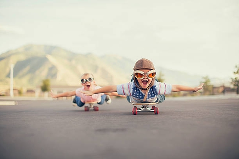 Young Boy and Girl Imagine Flying On Skateboard