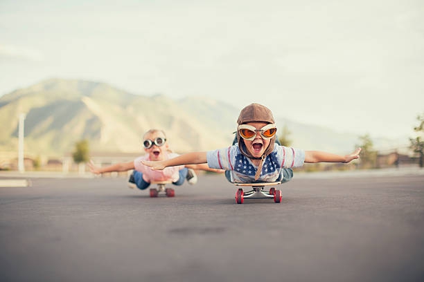 Young Boy and Girl Imagine Flying On Skateboard