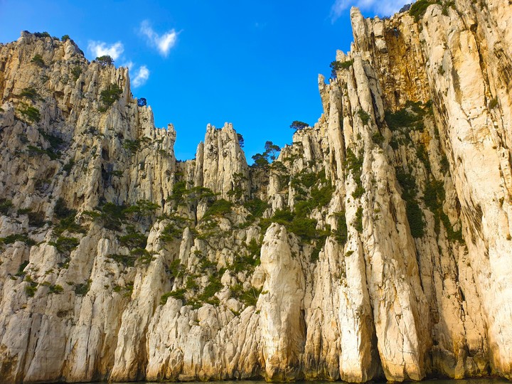 A big rock under a blue sky.