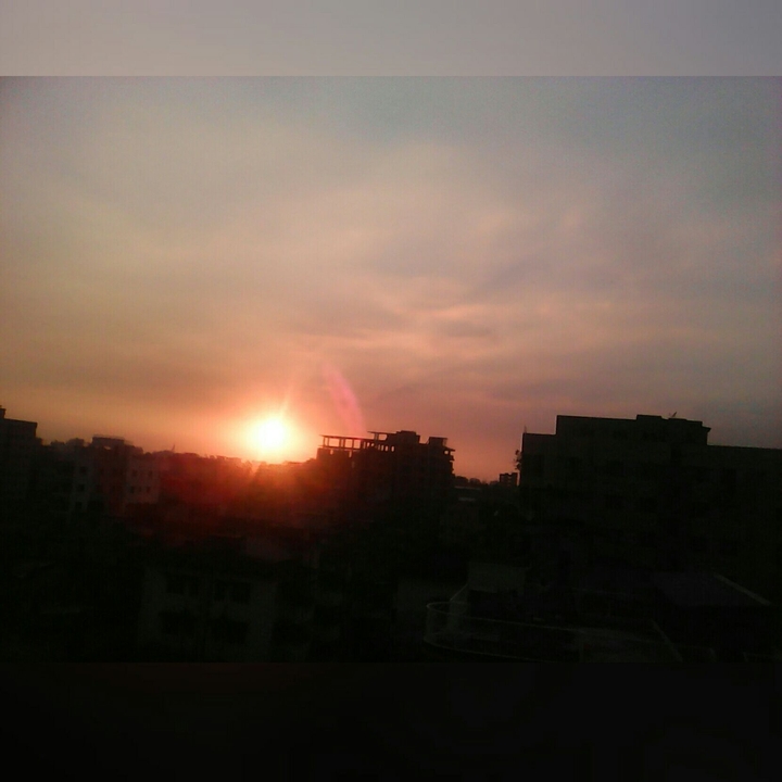 sun behind the building