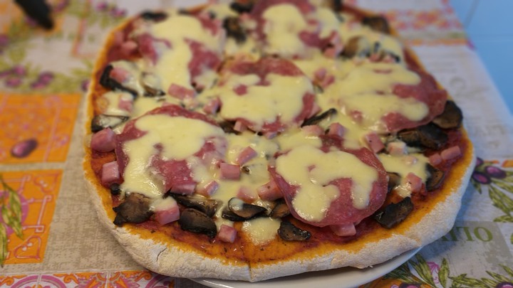 Pizza with ham, salami and mushrooms
