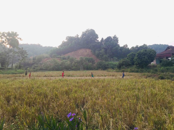 The children was playing football in the field