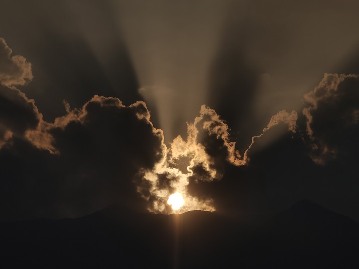 Sun giving golden shine to Black clouds.