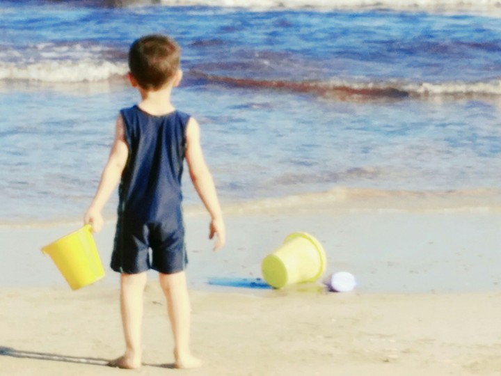 little kid playing at beach Alexandria