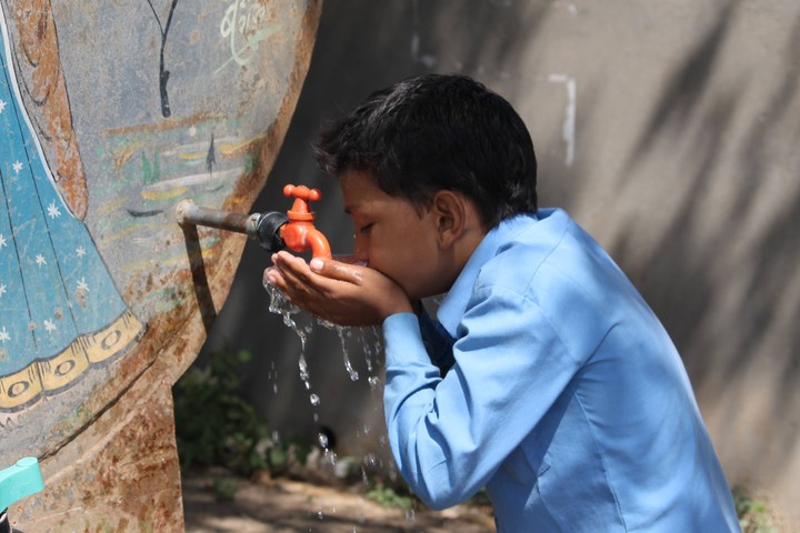 Thirsty child is drinking water