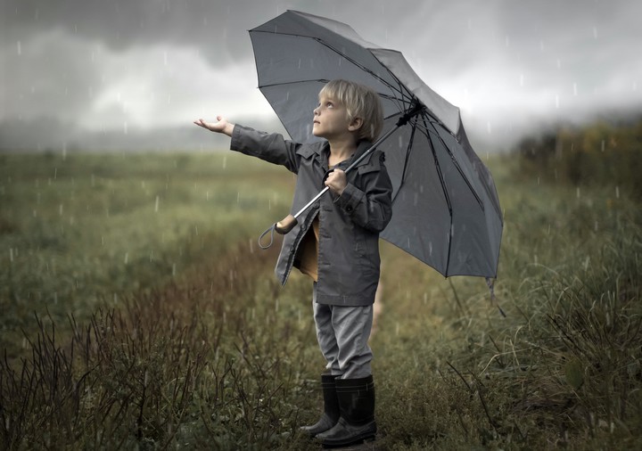 boy in the rain with Unbrella