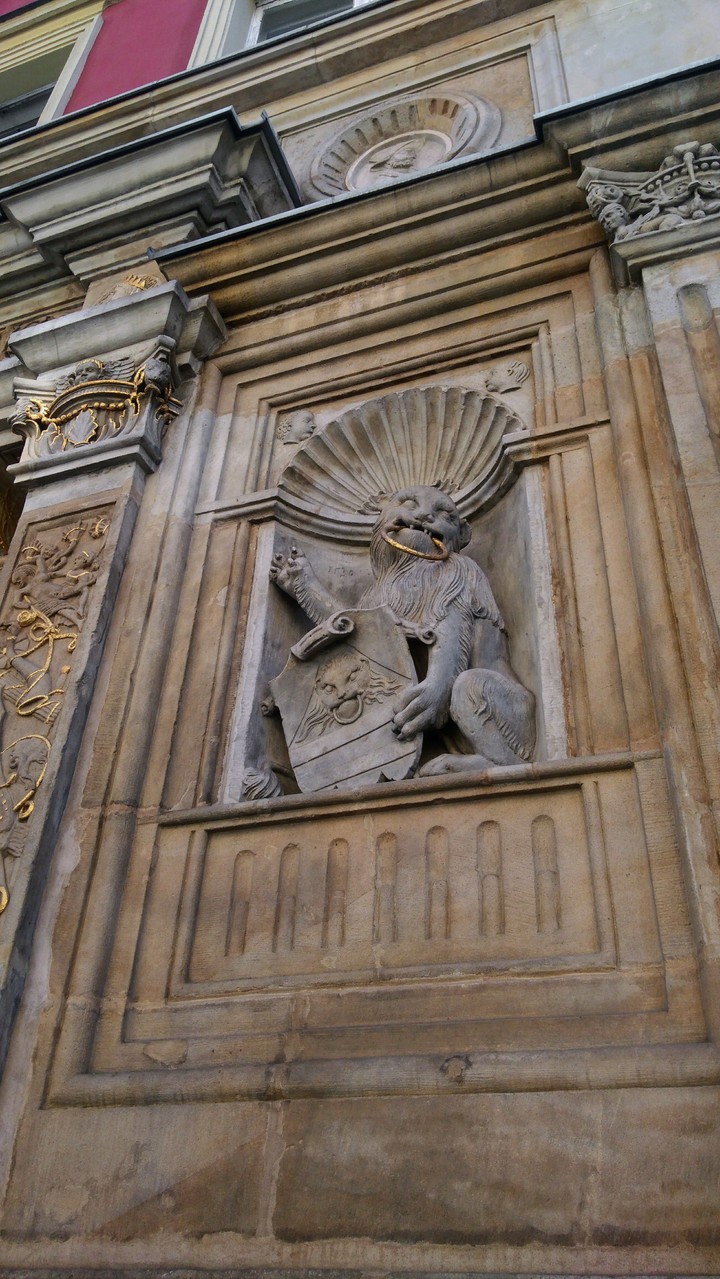 Stone gargoyle - low relief. Old rich architecture.
