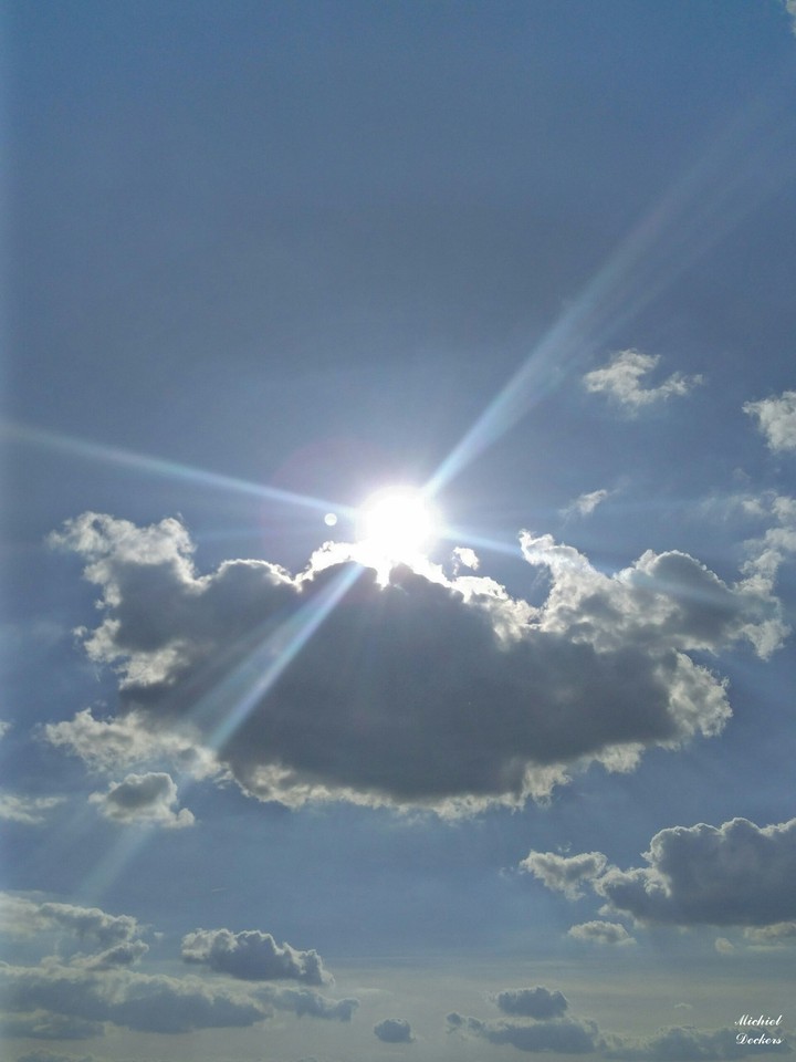 The sun shining brightly just behind the amazing cloud